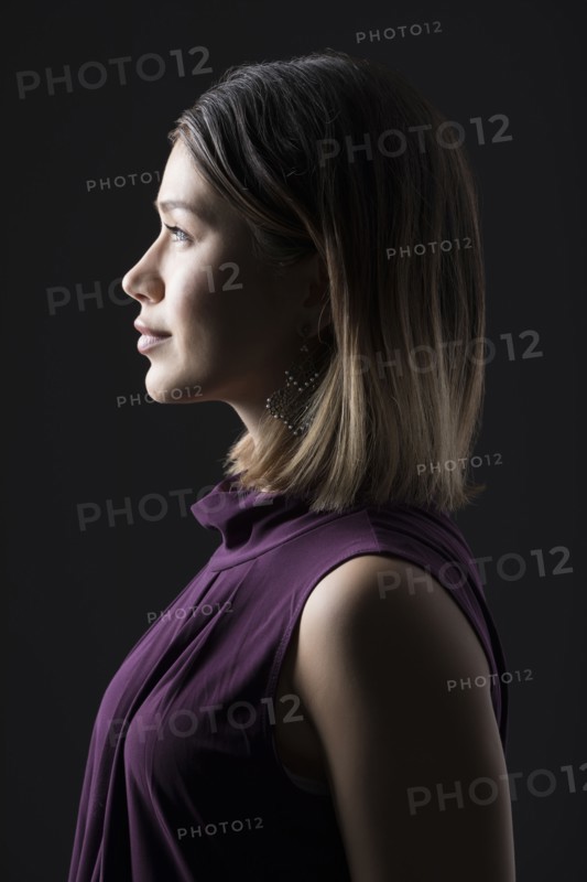 Profile of woman against black background