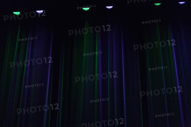 Stage curtain illuminated in green and blue
