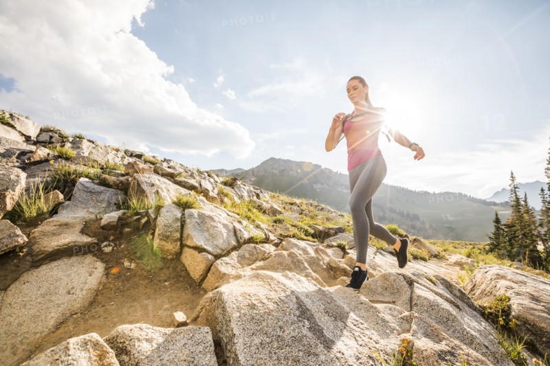 Woman jogging in mountains in summer