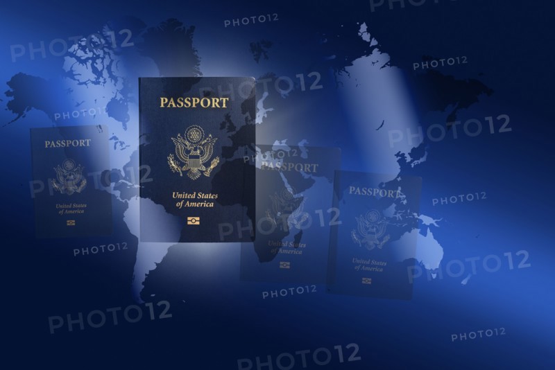 US passports against blue world map