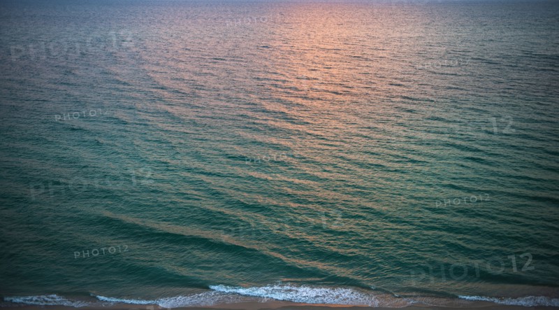 Rippled ocean surface reflecting sunlight
