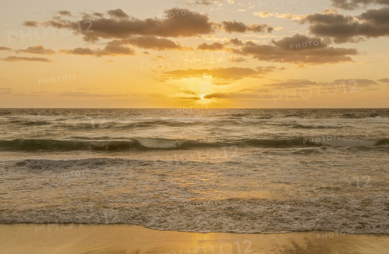 Sun rising above ocean