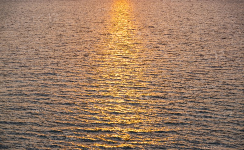 Rippled ocean surface reflecting sunlight