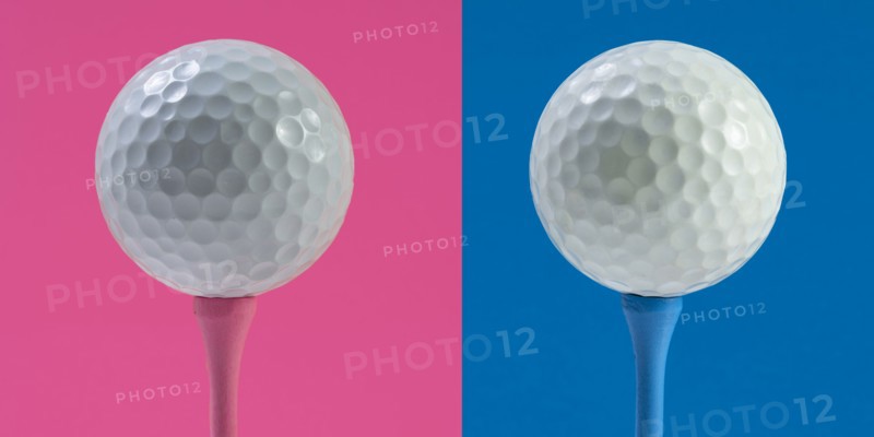 Golf balls on tee against pink and blue background