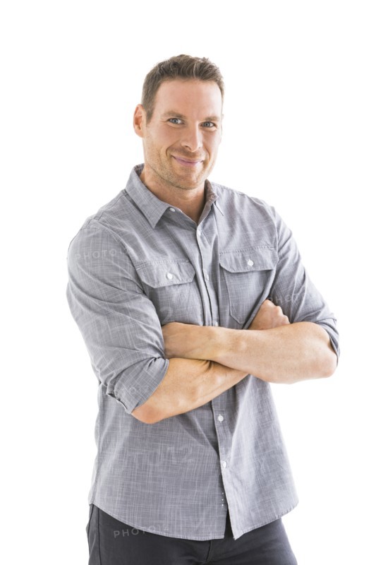 Studio portrait of smiling man with arms crossed