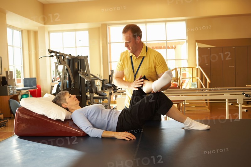 Physical therapist working with patient