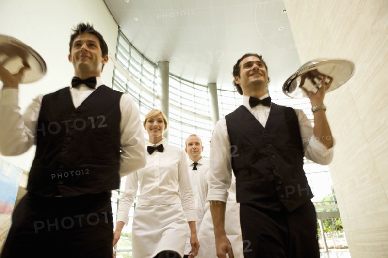 Group of waiters carrying trays