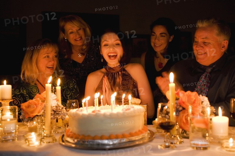 Group of friends celebrating birthday in restaurant
