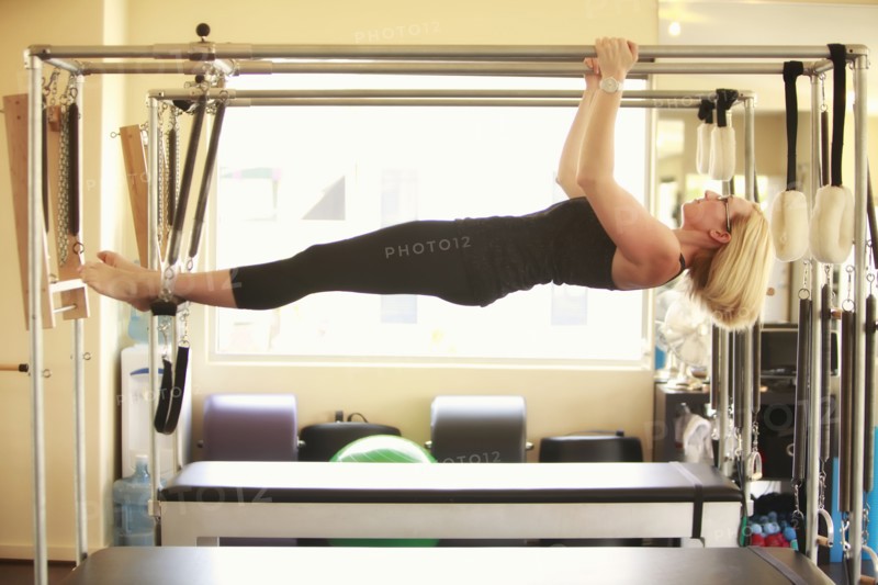 Woman training on pilates equipment