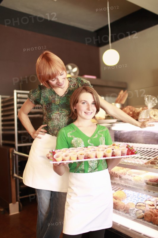 Owner and daughter (10-11) in small bakery