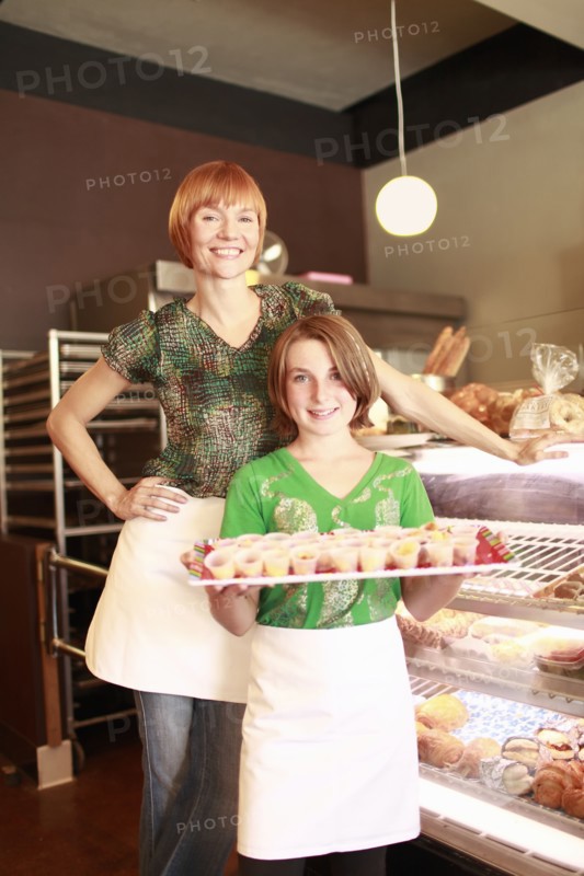 Owner and daughter (10-11) in small bakery