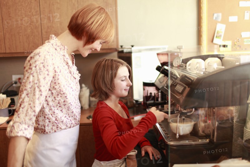 Owner and daughter (10-11) in small bakery