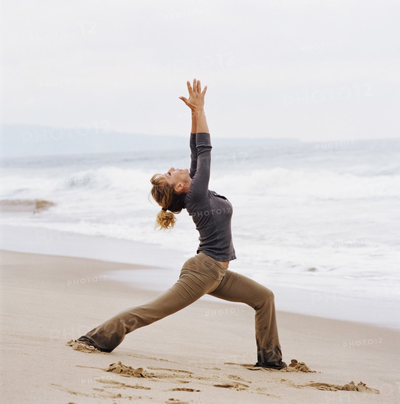 Woman doing yoga on beach