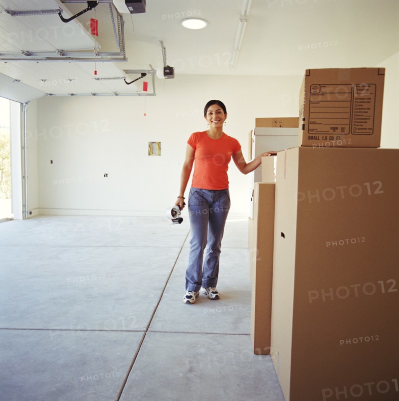 Woman in garage with moving boxes