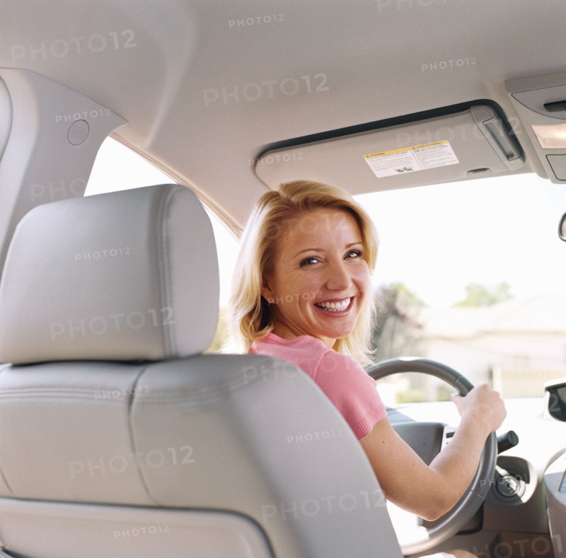 Portrait of woman sitting in drivers seat of car