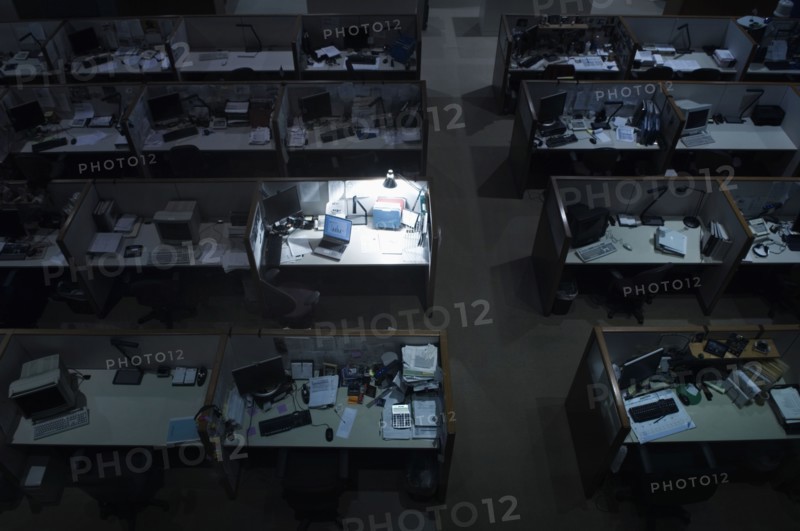 Illuminated desk in dark office