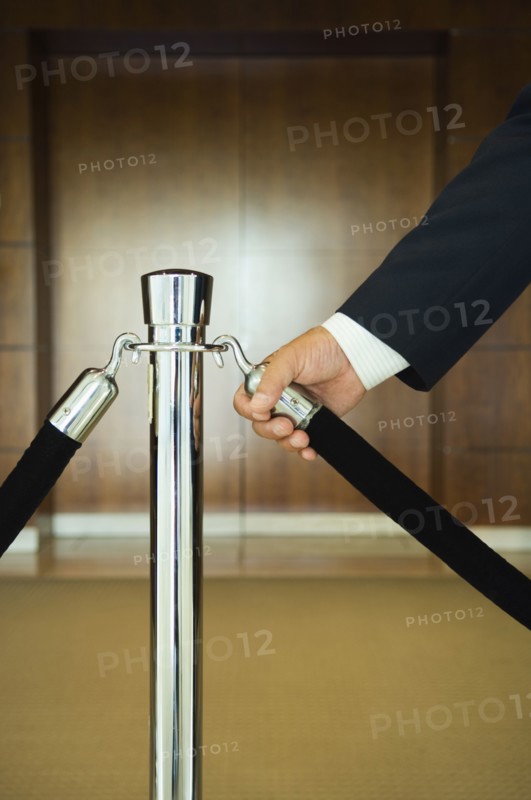 Man holding velvet rope