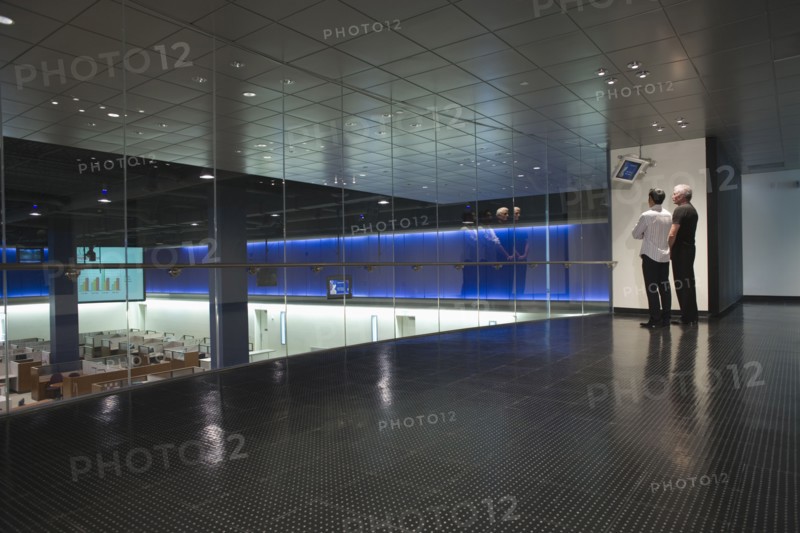 Businessmen watching data screen in modern office