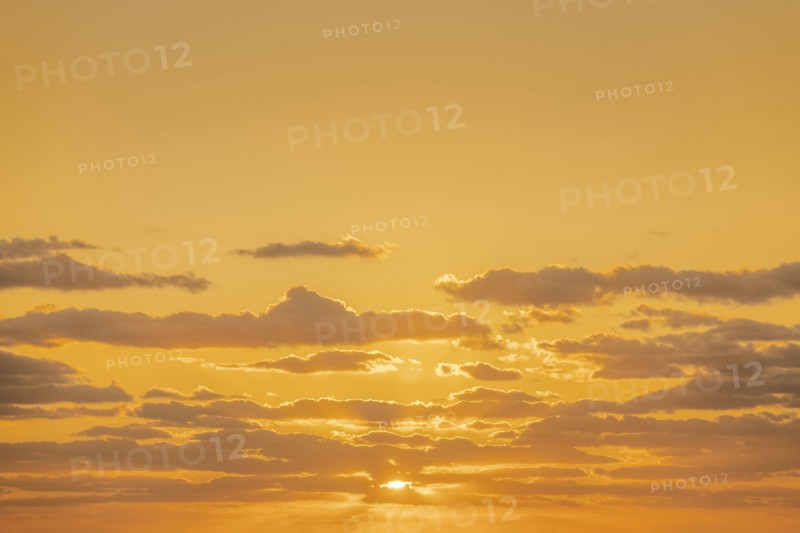 Golden clouds on sky at sunrise