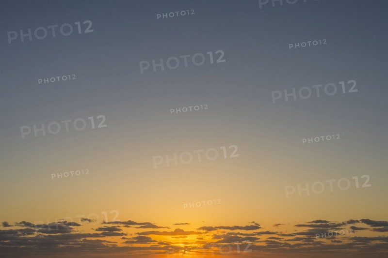Golden sunrise sky with low clouds