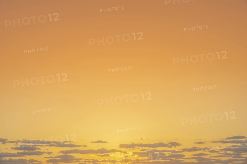 Golden sunrise sky with low clouds
