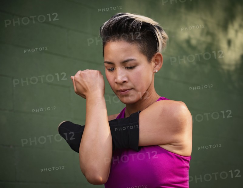Athletic woman with amputated hand stretching arm