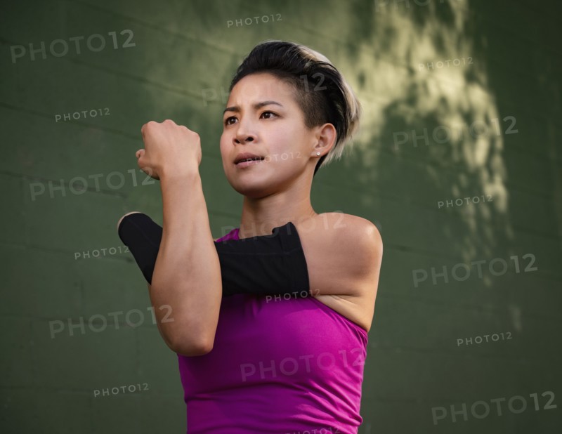 Athletic woman with amputated hand stretching arm