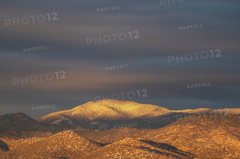 Light snow on Sangre de Cristo Mountains at sunset