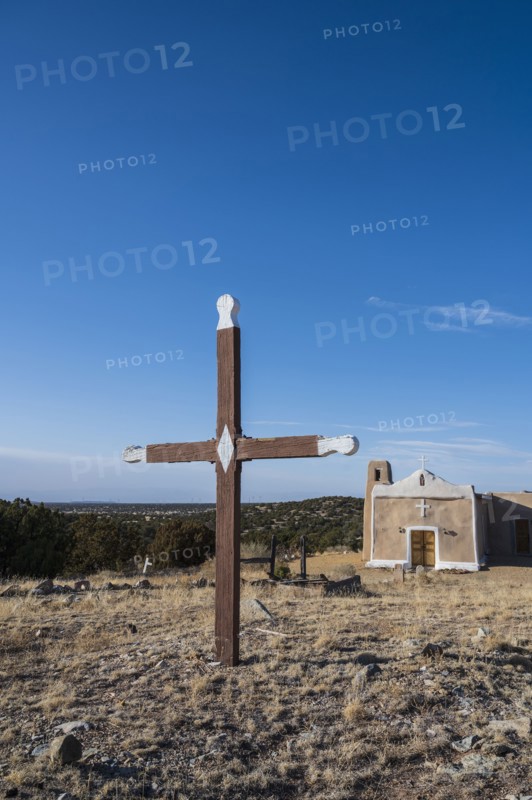 San Francisco de Asis Church with old wooden cross in foreground