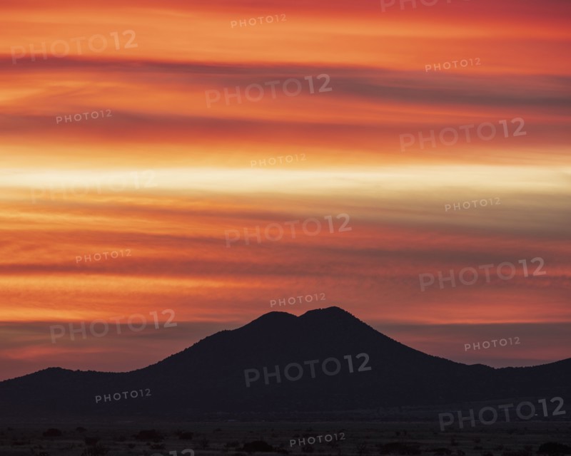 USA, New Mexico, Santa Fe, Silhouette of mountain against orange sky at sunset