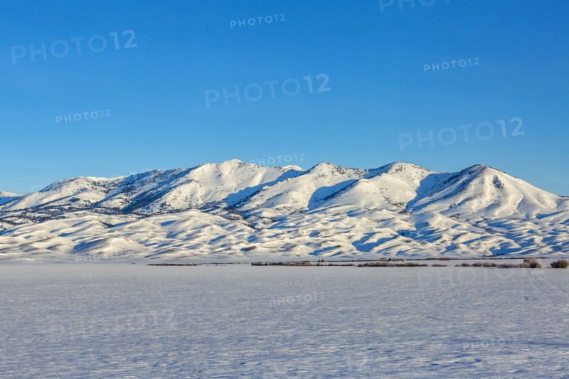 Snow covered field and Soldier Mountain on sunny day