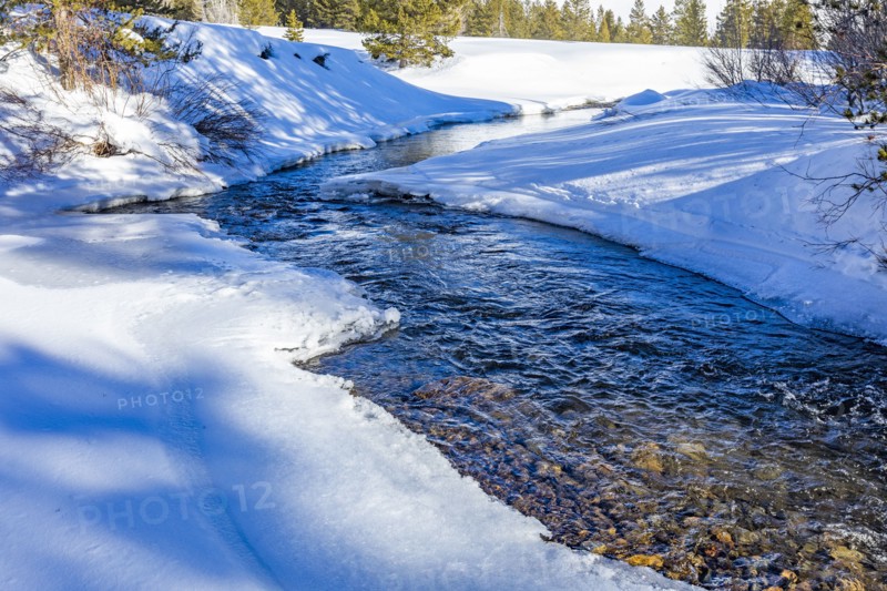 Creek in snow covered landscape
