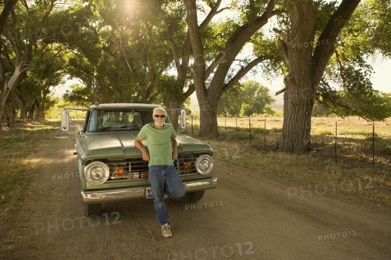 Man leaning on pick-up truck