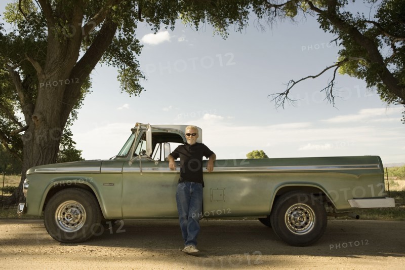 Man leaning on pick-up truck
