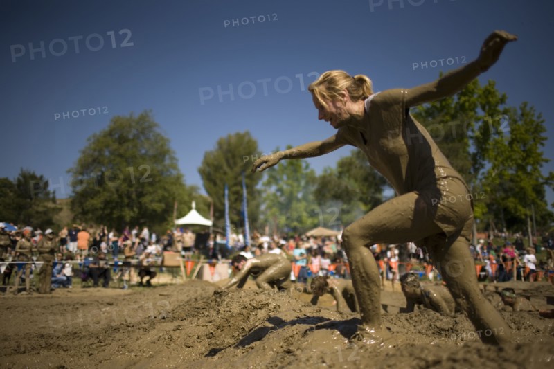 Sportswoman running in mud