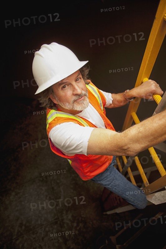 Worker descending ladder