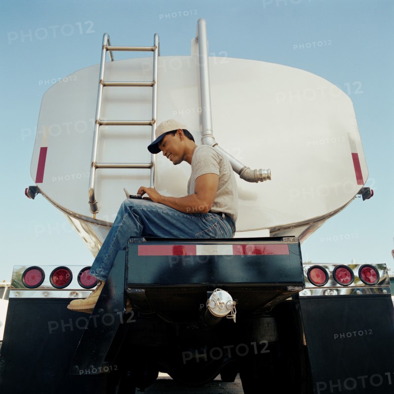 Truck driver sitting on his vehicle