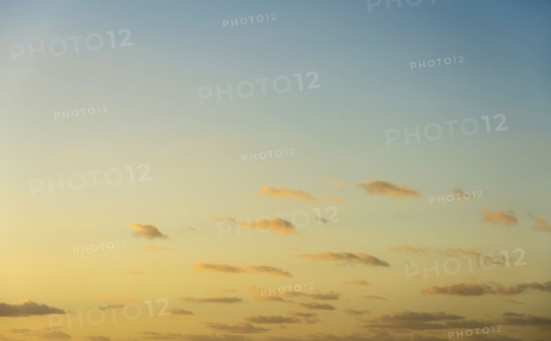Blue sky with small calm clouds at sunrise