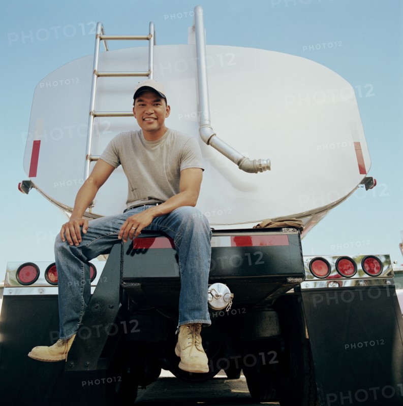 Truck driver sitting on his vehicle
