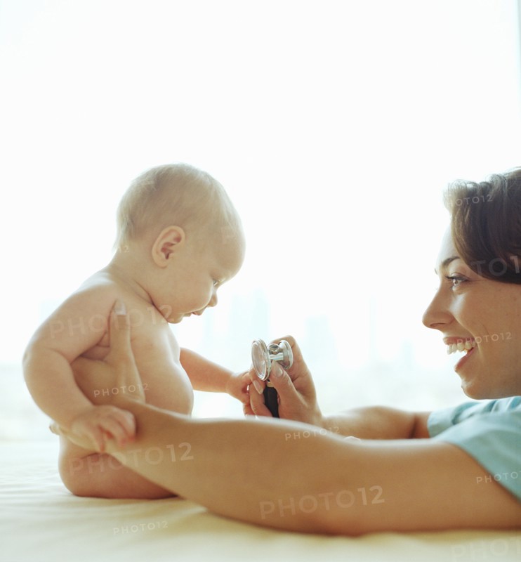 Doctor examining baby girl