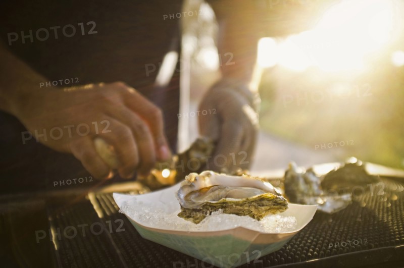Man shucking fresh oysters