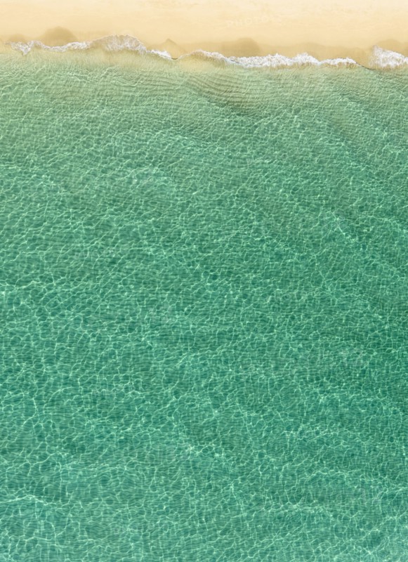 Overhead view of turquoise ocean and beach