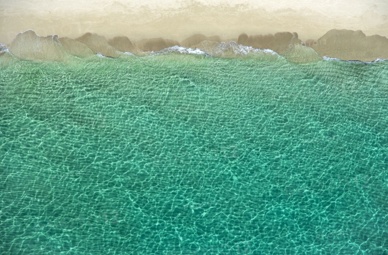 Overhead view of turquoise ocean and beach