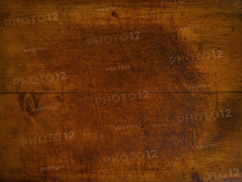 Close-up of worn antique cutting board with knife cut marks
