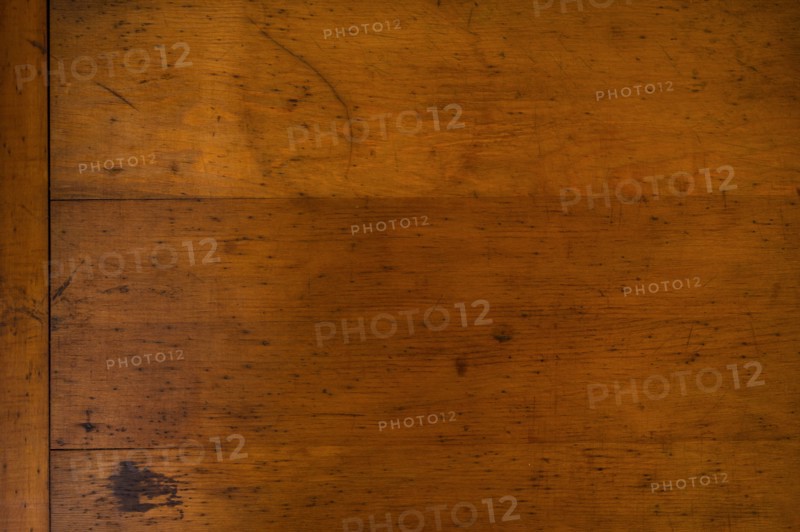 Close-up of worn antique cutting board with knife cut marks