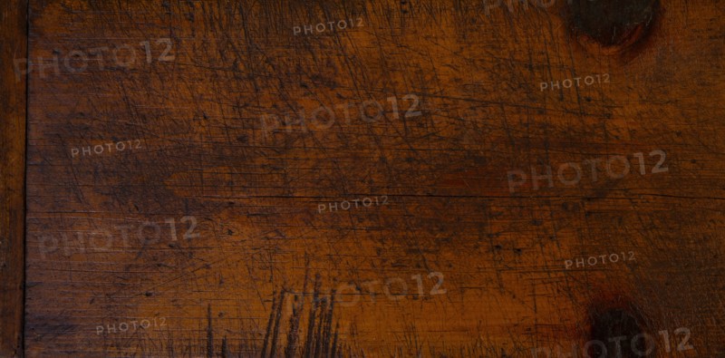 Close-up of worn antique cutting board with knife cut marks