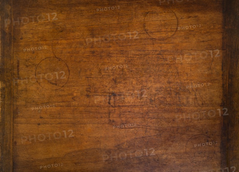 Close-up of worn antique cutting board with drinking glass rings