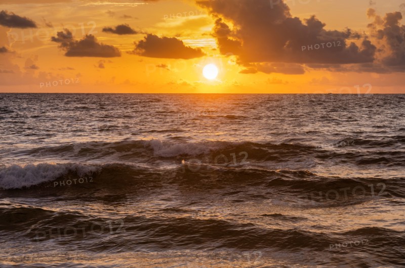 Sun rising over ocean
