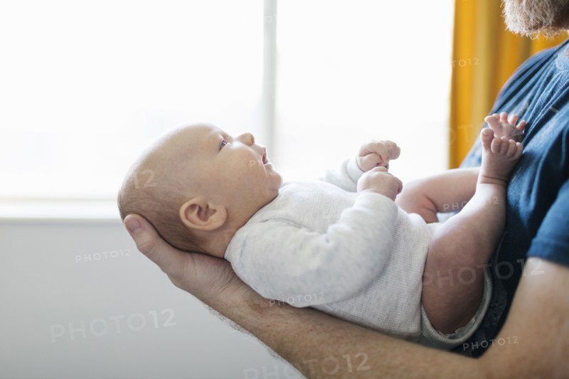 Close-up of father holding newborn son
