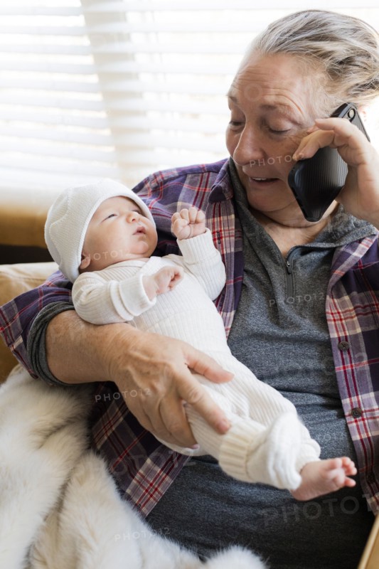 Grandmother holding newborn grandson